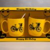 হ্যাপি বার্থডে স্মাইল মগ গিফট সেট – ইয়েলো সিরামিক কাপল মগ বাইসাইকেল ডিজাইনে – জন্মদিনের উপহার